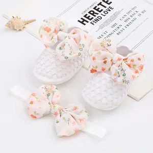 Detailansicht weißer Netz-Babyschuhe mit Blumenschleifen und passendem Stirnband-Set