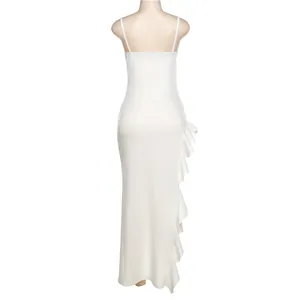 Back view of a white spaghetti strap maxi dress with elegant ruffle detail on side.