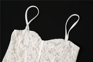 Close-up of white floral lace dress bodice with thin spaghetti straps and sweetheart neck