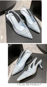 Detailed view of light blue tweed slingback pumps with a classic pointed toe and kitten heel.
