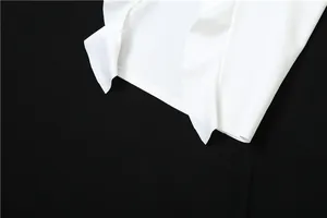 Close-up detail of delicate white ruffle edge and lettuce trim on a summer fashion dress