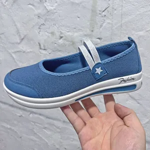 Detailed side view of a blue breathable mesh slip-on shoe featuring white wedge sole