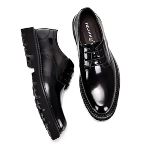 Detail of men's black patent leather Derby shoes with high-gloss finish and thick sole