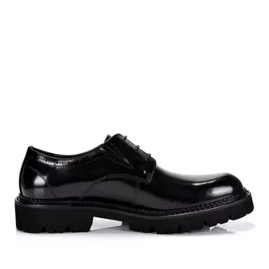 Side profile of shiny black patent leather men's derby shoes with chunky platform soles.