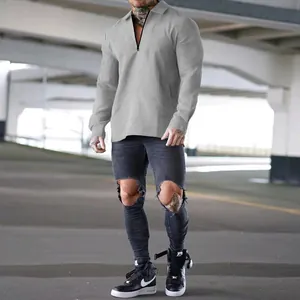 Visual detail of grey waffle-knit texture and zipper design on men's long sleeve polo