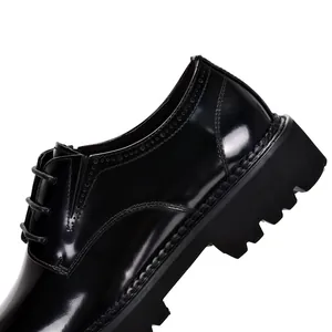 Close-up of black patent leather Derby shoe showing thick sole and stitching details