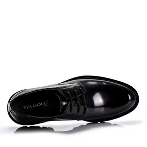 Top view of black patent leather derby shoes with lace-up design and thick sole