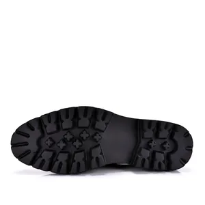 Detailed macro view of the thick black rubber lugged outsole on this men's Derby shoe