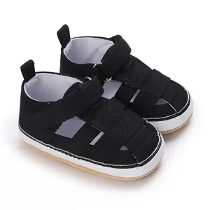 Close-up of black classic baby canvas sandals with soft non-slip rubber sole and velcro strap