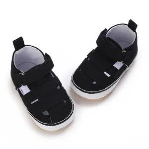 Detail view of black infant soft sole sneakers with breathable mesh and Velcro closure