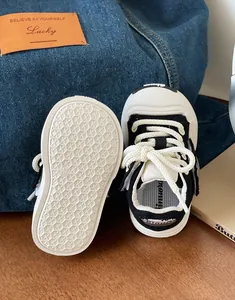 Detail view of toddler canvas shoes showing non-slip sole and lace-up design