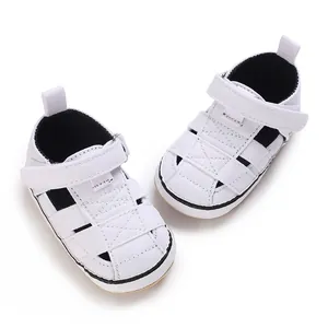 Classic white baby sandals with non-slip rubber soles and velcro straps for infants