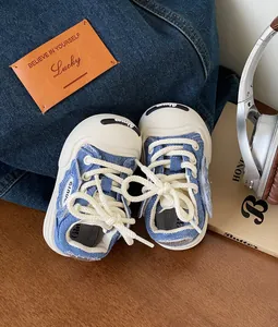 Denim style baby canvas walking shoes with soft soles and white laces detail view
