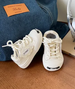 Off-white toddler canvas walking shoes with soft soles and lace-up design for boys