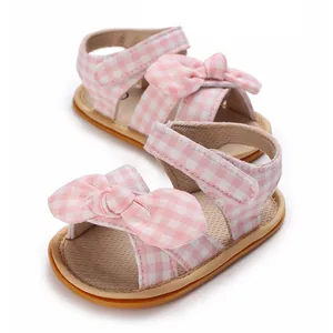 Detailed view of pink gingham baby girl walker sandals featuring a soft sole and bow