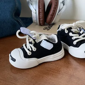 Black and white toddler canvas walking shoes with soft non-slip soles for baby boys and girls
