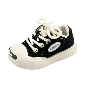 Classic black and white toddler walking shoes with soft soles and canvas finish
