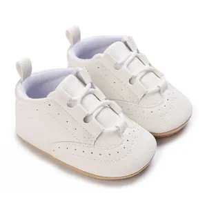 Detailed close-up of white baby soft sole sneakers featuring litchi grain leather texture
