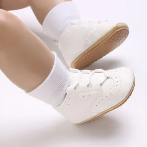 Detail shot of white soft-sole baby walking shoes with anti-slip rubber outsoles