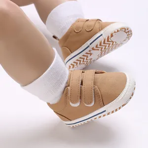 Detail of brown baby walking shoes with anti-slip chevron sole and velcro straps