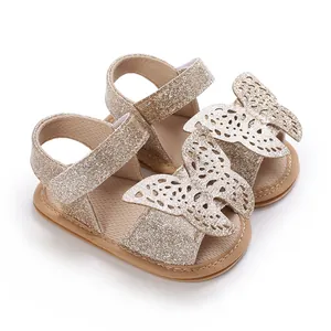 Close-up of gold glitter baby sandals with hollow butterfly design for 0-1 year old.