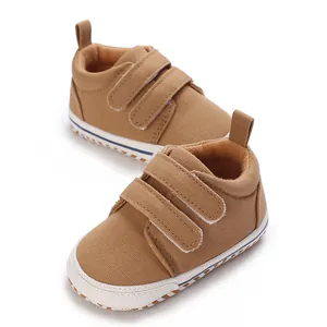 Detailed view of high-quality brown infant walking shoes with double hook and loop straps.
