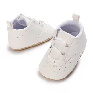 Detail view of white baby soft sole sneakers with breathable punched hole design for toddlers
