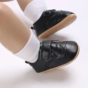 Close-up of black leather baby walker shoes with anti-slip rubber sole and velcro