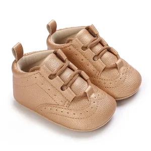 Detailed macro view of rose gold baby soft sole sneakers with pebble leather texture