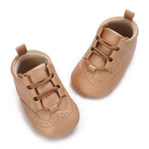 Bronze soft sole baby sneakers for infants 0-1 years with elastic laces and brogue detail.