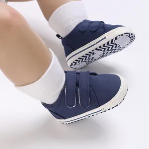 Close-up of navy blue baby walking shoes with soft non-slip soles and Velcro straps