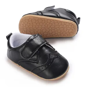 Classic black infant boy walking shoes featuring anti-slip rubber sole and velcro strap design