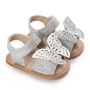 Close-up detail of silver glitter baby sandals featuring intricate butterfly wing decorations
