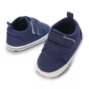 High-quality navy blue canvas infant walking shoes with dual hook-and-loop strap closure.