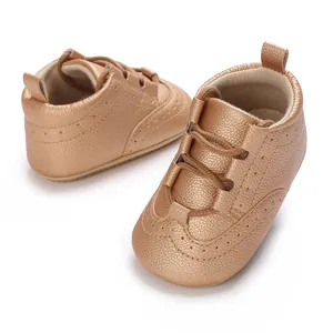 Close-up of bronze faux leather baby soft sole shoes with brogue detail