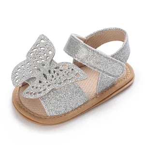 Close-up of a baby girl silver glitter sandal featuring a large hollow butterfly design