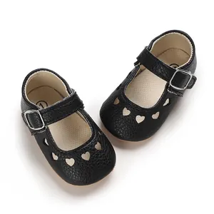 Top-down view of black baby Mary Jane shoes featuring heart cutouts and buckle straps