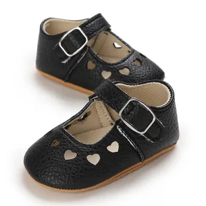 Close-up of baby girl Mary Jane shoes with heart cutouts and non-slip rubber soles