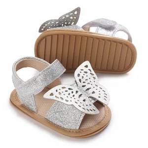 Detailed close-up of silver glitter baby girls sandals with a decorative butterfly cutout design