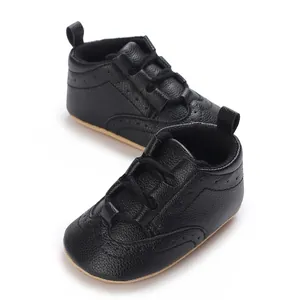 Macro view of black baby soft sole sneakers with premium pebbled faux leather texture