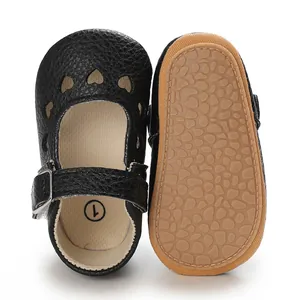 Detailed view of infant black heart cutout shoes with non-slip rubber soles