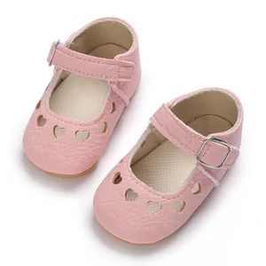 Detailed view of pink baby Mary Jane shoes with heart cutouts and non-slip rubber sole