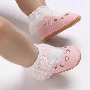 Detailed view of pink baby princess shoes featuring heart cut-outs and delicate lace trim