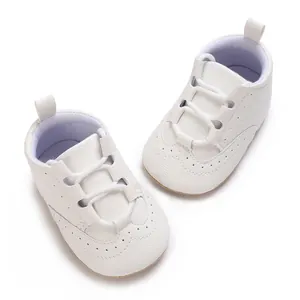Soft-sole white leather baby sneakers featuring perforated details and elastic laces
