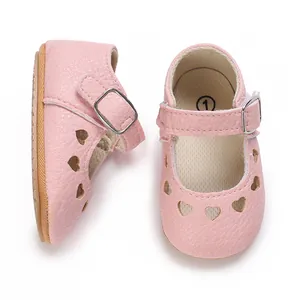 Top and side view detail of pink infant princess shoes with cute heart cutouts.
