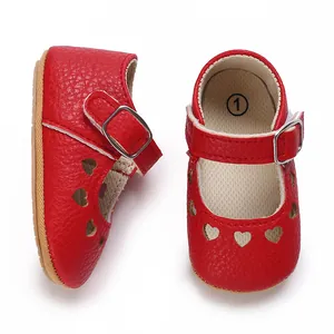 Macro view of red baby princess shoes with heart cutouts and non-slip rubber soles