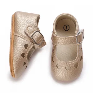 Detailed view of golden baby princess shoes with heart cutouts and soft buckle strap