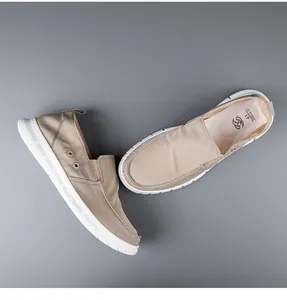 Top-down view of khaki men's slip-on loafers with breathable canvas and soft white sole.