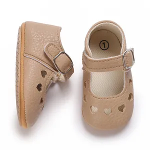 Close-up of tan baby Mary Jane shoes with heart cutouts and anti-slip rubber sole