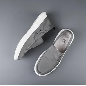 Top view of grey breathable canvas slip-on loafers for men with durable white soles